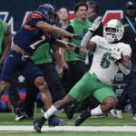 
              North Texas running back Ikaika Ragsdale (6) is stopped by UTSA cornerback Corey Mayfield Jr. (2) during the first half of an NCAA college football game for the Conference USA championship in San Antonio, Friday, Dec. 2, 2022. (AP Photo/Eric Gay)
            