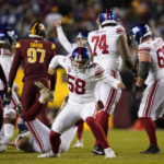 New York Giants long snapper Casey Kreiter (58) celebrates a field goal by teammate Graham Gano during the second half of an NFL football game against the Washington Commanders, Sunday, Dec. 18, 2022, in Landover, Md. (AP Photo/Patrick Semansky)