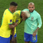 
              Brazil's Neymar, center, cries as he walks off the field with teammate Thiago Silva, left, and Brazil's Dani Alves after their loss in the World Cup quarterfinal soccer match against Croatia, at the Education City Stadium in Al Rayyan, Qatar, Friday, Dec. 9, 2022. (AP Photo/Alessandra Tarantino)
            