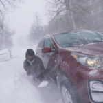
              Gamaliel Vega tries to dig out his car on Lafayette Avenue after he got stuck in a snowdrift about a block from home while trying to help rescue his cousin, who had lost power and heat with a baby at home across town during a blizzard in Buffalo, N.Y., on Saturday, Dec. 24, 2022. (Derek Gee/The Buffalo News via AP)
            