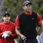 
              Tiger Woods, right, and his son Charlie Woods, left, prepare to tee off on the 3rd hole during the final round of the PNC Championship golf tournament Sunday, Dec. 18, 2022, in Orlando, Fla. (AP Photo/Kevin Kolczynski)
            