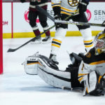 Boston Bruins goaltender Jeremy Swayman looks at the puck in the net after giving up a goal to Arizona Coyotes' Lawson Crouse during the third period of an NHL hockey game in Tempe, Ariz., Friday, Dec. 9, 2022. The Coyotes won 4-3. (AP Photo/Ross D. Franklin)