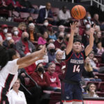 
              Gonzaga guard Kaylynne Truong (14) takes a 3-point shot against Stanford guard Agnes Emma-Nnopu (2) during the first half of an NCAA college basketball game in Stanford, Calif., Sunday, Dec. 4, 2022. (AP Photo/Tony Avelar)
            