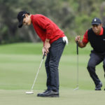 
              Charlie Woods, left, putts on the 2nd green while Tiger Woods, right, watches during the final round of the PNC Championship golf tournament Sunday, Dec. 18, 2022, in Orlando, Fla. (AP Photo/Kevin Kolczynski)
            