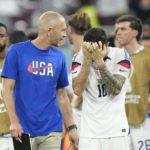 
              Head coach Gregg Berhalter of the United States, and Christian Pulisic of the United States leave the pitch at the end of the World Cup round of 16 soccer match between the Netherlands and the United States, at the Khalifa International Stadium in Doha, Qatar, Saturday, Dec. 3, 2022. (AP Photo/Francisco Seco)
            