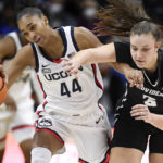 Connecticut's Aubrey Griffin (44) is fouled by Providence's Meghan Huerter (3) while stealing the ball in the first half of an NCAA college basketball game, Friday, Dec. 2, 2022, in Storrs, Conn. (AP Photo/Jessica Hill)