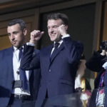 
              France's President Emmanuel Macron, center, gestures as he arrives on the tribune ahead of the World Cup final soccer match between Argentina and France at the Lusail Stadium in Lusail, Qatar, Sunday, Dec. 18, 2022. (AP Photo/Martin Meissner)
            