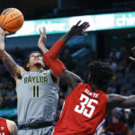 Baylor forward Jalen Bridges (11) attempts to shoot as Washington State forward Mouhamed Gueye (35) defends during the first half of an NCAA college basketball game on Sunday, Dec. 18, 2022, in Dallas. (AP Photo/Brandon Wade)