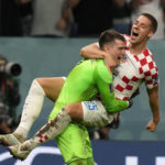 
              Croatia's Mario Pasalic celebrates with Croatia's goalkeeper Dominik Livakovic after scoring the final penalty at the penalty shootout of the World Cup round of 16 soccer match between Japan and Croatia at the Al Janoub Stadium in Al Wakrah, Qatar, Monday, Dec. 5, 2022. (AP Photo/Frank Augstein)
            