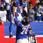 New York Giants' Saquon Barkley, left, celebrates his touchdown with Jon Feliciano during the first half of an NFL football game against the Washington Commanders, Sunday, Dec. 4, 2022, in East Rutherford, N.J. (AP Photo/John Munson)