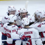 
              Washington Capitals' Alex Ovechkin, center, celebrates with teammates his 800th career goal, on a hat trick against the Chicago Blackhawks during the third period of an NHL hockey game Tuesday, Dec. 13, 2022, in Chicago. (AP Photo/Charles Rex Arbogast)
            