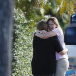
              Two people embrace on a street in Kailua, where at least a man died and a few others were seriously injured while building a retaining wall in Honolulu on Friday, Dec. 30, 2022. (Cindy Ellen Russell/Honolulu Star-Advertiser via AP)
            