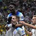 England's Jordan Henderson, center, celebrates with his teammates after scoring his side's first goal during the World Cup round of 16 soccer match between England and Senegal, at the Al Bayt Stadium in Al Khor, Qatar, Sunday, Dec. 4, 2022. (AP Photo/Hassan Ammar)
