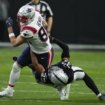New England Patriots tight end Hunter Henry is taken down by Las Vegas Raiders cornerback Tyler Hall during the first half of an NFL football game between the New England Patriots and Las Vegas Raiders, Sunday, Dec. 18, 2022, in Las Vegas. (AP Photo/John Locher)