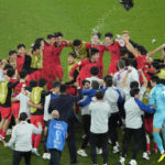 
              South Korea's team players celebrate after the World Cup group H soccer match between South Korea and Portugal, at the Education City Stadium in Al Rayyan, Qatar, Friday, Dec. 2, 2022. (AP Photo/Darko Bandic)
            