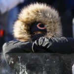 A Chicago Bears fan watches from the stands in the first half of an NFL football game between the Buffalo Bills and the Chicago Bears in Chicago, Saturday, Dec. 24, 2022. (AP Photo/Nam Y. Huh)