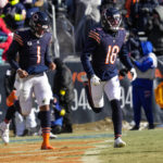 Chicago Bears quarterback Justin Fields (1) and Chicago Bears wide receiver Dante Pettis (18) come off the field following a touchdown catch by Pettis in the first half of an NFL football game against the Buffalo Bills in Chicago, Saturday, Dec. 24, 2022. (AP Photo/Nam Y. Huh)