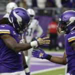 Minnesota Vikings running back Dalvin Cook, left, celebrates with teammate Alexander Mattison after catching a 64-yard touchdown pass during the second half of an NFL football game against the Indianapolis Colts, Saturday, Dec. 17, 2022, in Minneapolis. (AP Photo/Andy Clayton-King)