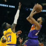 Phoenix Suns forward Mikal Bridges, right, shoots over Los Angeles Lakers guard Dennis Schroder (17) during the second half of an NBA basketball game, Monday, Dec. 19, 2022, in Phoenix. (AP Photo/Rick Scuteri)