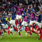 
              France players celebrate their team victory over England at the end of the World Cup quarterfinal soccer match between England and France, at the Al Bayt Stadium in Al Khor, Qatar, Sunday, Dec. 11, 2022. (AP Photo/Christophe Ena)
            