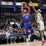 
              New York Knicks guard Jalen Brunson (11) shoots over Indiana Pacers guard Andrew Nembhard (2) during the first half of an NBA basketball game in Indianapolis, Sunday, Dec. 18, 2022. (AP Photo/AJ Mast)
            