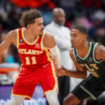 
              Atlanta Hawks guard Trae Young (11) is guarded by Charlotte Hornets guard Theo Maledon (9) during the first half of an NBA basketball game Friday, Dec. 16, 2022, in Charlotte, N.C. (AP Photo/Rusty Jones)
            