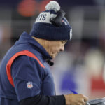 New England Patriots head coach Bill Belichick reviews print outs of previous plays during the first half of an NFL football game against the Buffalo Bills, Thursday, Dec. 1, 2022, in Foxborough, Mass. (AP Photo/Michael Dwyer)
