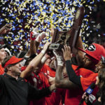 Georgia head coach Kirby Smart and defensive lineman Jalen Carter (88) hoist the trophy after defeating LSU in the Southeastern Conference Championship football game Saturday, Dec. 3, 2022 in Atlanta. (AP Photo/John Bazemore)