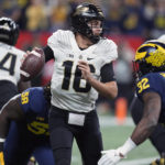 Purdue quarterback Aidan O'Connell drops back to pass during the first half of the Big Ten championship NCAA college football game against Michigan, Saturday, Dec. 3, 2022, in Indianapolis. (AP Photo/Darron Cummings)
