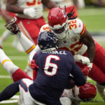 
              Houston Texans quarterback Jeff Driskel (6) is stopped by Kansas City Chiefs defensive end George Karlaftis, center, and linebacker Nick Bolton (32) during the first half of an NFL football game Sunday, Dec. 18, 2022, in Houston. (AP Photo/David J. Phillip)
            