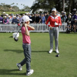 
              Annika Sorenstam, right, talks to her son Will McGee, left, on the first tee during the first round of the PNC Championship golf tournament Saturday, Dec. 17, 2022, in Orlando, Fla. (AP Photo/Kevin Kolczynski)
            