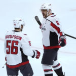 Washington Capitals' Alex Ovechkin (8) celebrates his goal with Erik Gustafsson during the first period of an NHL hockey game against the Chicago Blackhawks Tuesday, Dec. 13, 2022, in Chicago. (AP Photo/Charles Rex Arbogast)