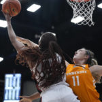 Stanford forward Kiki Iriafen, left, shoots while defended by Tennessee forward Karoline Striplin during the first half of an NCAA college basketball game in Stanford, Calif., Sunday, Dec. 18, 2022. (AP Photo/Godofredo A. Vásquez)