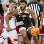 
              Lehigh's Jakob Alamudun (0) drives against Wisconsin's Connor Essegian (3) during the second half of an NCAA college basketball game Thursday, Dec. 15, 2022, in Madison, Wis.  (AP Photo/Andy Manis)
            