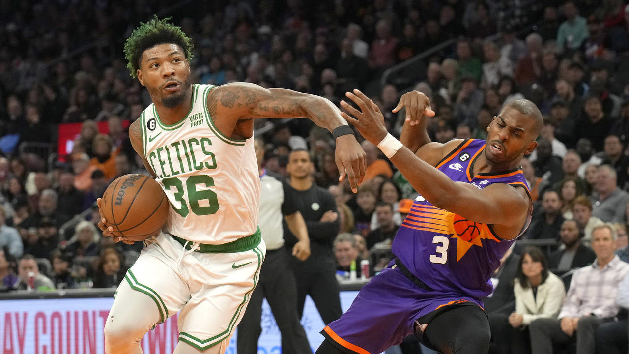 Phoenix Suns guard Chris Paul draws the offensive foul on Boston Celtics guard Marcus Smart (36) du...