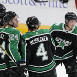 
              Dallas Stars' Jason Robertson, right, skates back to the bench after celebrating with Miro Heiskanen (4), Roope Hintz (24), Joe Pavelski (16) and Jamie Benn (14) after Robertson scored his third goal of the night against the Anaheim Ducks, during the third period of an NHL hockey game Thursday, Dec. 1, 2022, in Dallas. (AP Photo/Tony Gutierrez)
            