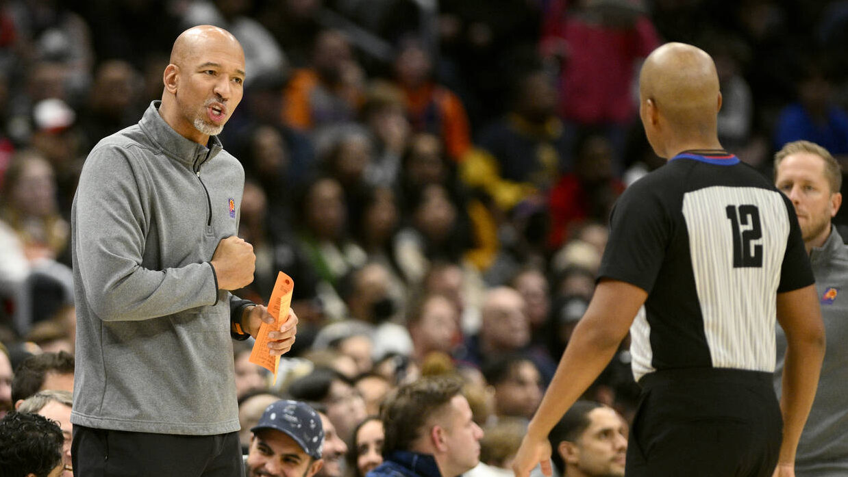 Phoenix Suns head coach Monty Williams, left, reacts to referee CJ Washington (12) during the first...
