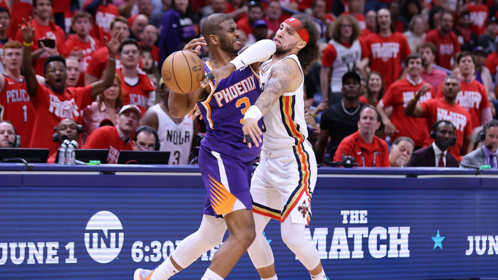 Chris Paul #3 of the Phoenix Suns drives against Jose Alvarado #15 of the New Orleans Pelicans duri...