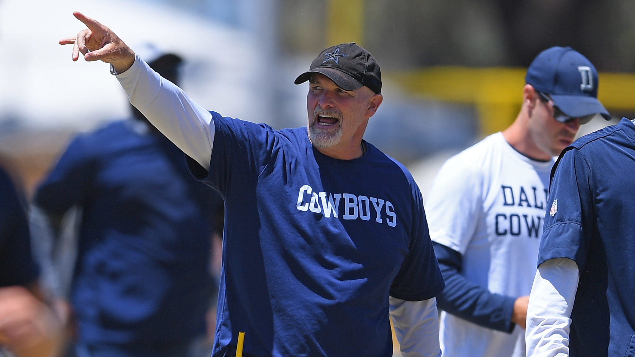 Defensive coordinator Dan Quinn of the Dallas Cowboys runs drills during training camp at River Rid...