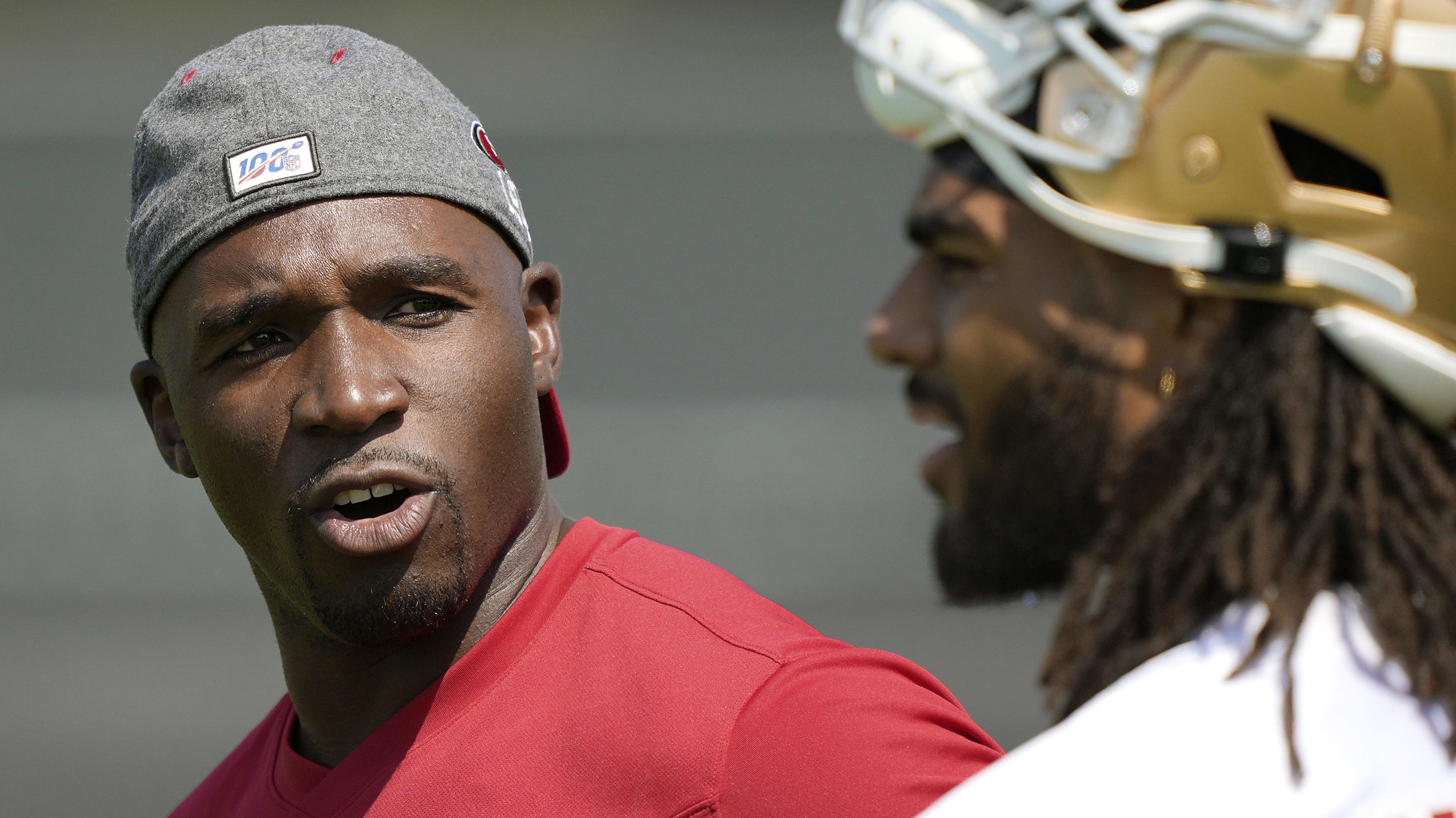 Defensive Coordinator DeMeco Ryans of the San Francisco 49ers talks with linebacker Fred Warner #54...