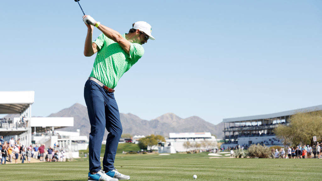 Swimmer Michael Phelps plays his shot from the 17th tee during the pro-am prior to the WM Phoenix O...