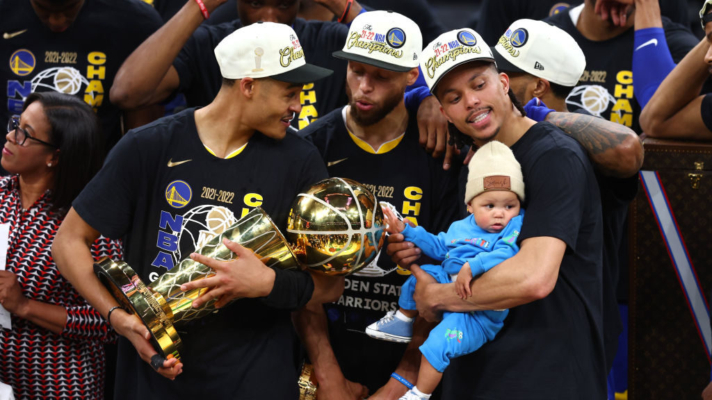 Jordan Poole #3, Stephen Curry #30 and Damion Lee #1 of the Golden State Warriors celebrate after d...