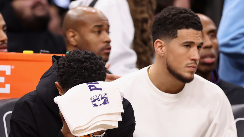 Cameron Payne #15 and Devin Booker #1 of the Phoenix Suns react on the bench during the final momen...