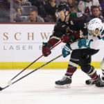 Christian Fischer #36 of the Arizona Coyotes shoots the puck under pressure from Mario Ferraro #38 of the San Jose Sharks during the second period of the NHL game at Mullett Arena on January 10, 2023 in Tempe, Arizona. (Photo by Christian Petersen/Getty Images)