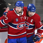 
              Montreal Canadiens' Josh Anderson (17) celebrates with teammate Nick Suzuki after scoring against the Toronto Maple Leafs during the second period of an NHL hockey game Saturday, Jan. 21, 2023, in Montreal. (Graham Hughes/The Canadian Press via AP)
            
