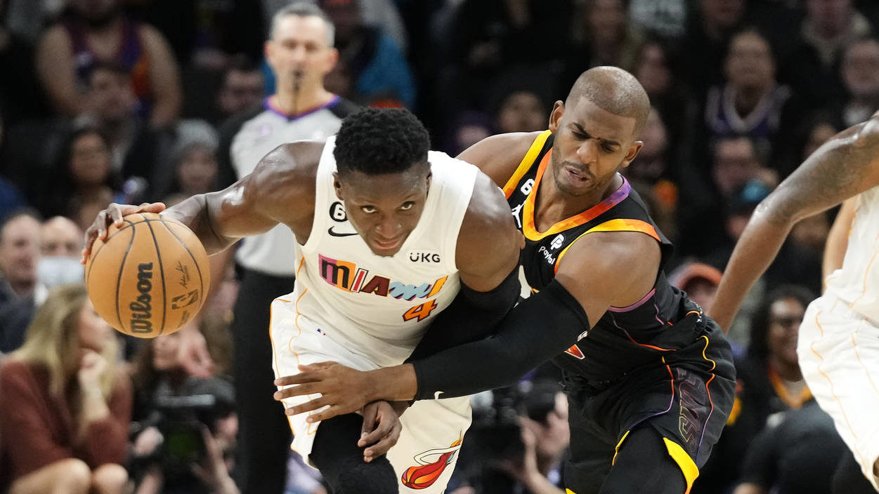 Phoenix Suns guard Chris Paul, right, fouls Miami Heat guard Victor Oladipo (4) during the first ha...