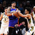 Phoenix Suns' Damion Lee (10) competes for the ball with Indiana Pacers' Andrew Nembhard (2) during the first half of an NBA basketball game in Phoenix, Saturday, Jan. 21, 2023. (AP Photo/Darryl Webb)