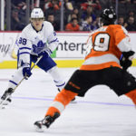 
              Toronto Maple Leafs' William Nylander, left, looks to pass the puck against the defense of Philadelphia Flyers' Noah Cates during the first period of an NHL hockey game, Sunday, Jan. 8, 2023, in Philadelphia. (AP Photo/Derik Hamilton)
            