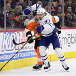 Toronto Maple Leafs' Timothy Liljegren, right, battles Philadelphia Flyers' Patrick Brown for the puck during the second period of an NHL hockey game, Sunday, Jan. 8, 2023, in Philadelphia. (AP Photo/Derik Hamilton)