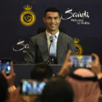 
              Cristiano Ronaldo smiles during a press conference for his official unveiling as a new member of Al Nassr soccer club in in Riyadh, Saudi Arabia, Tuesday, Jan. 3, 2023. Ronaldo, who has won five Ballon d'Ors awards for the best soccer player in the world and five Champions League titles, will play outside of Europe for the first time in his storied career. (AP Photo/Amr Nabil)
            
